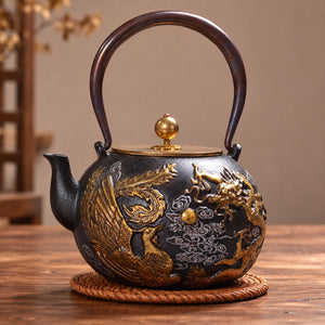 Longfeng cast iron teapot with dragon and phoenix relief on a woven trivet