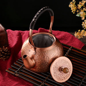 Auren copper teapot with the lid removed, showing the fine-mesh infuser inside