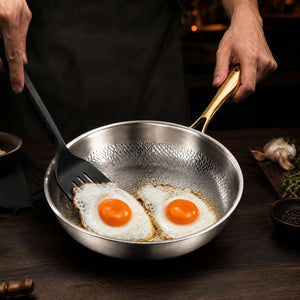 Frying two eggs in the hammered titanium frying pan with gold handle