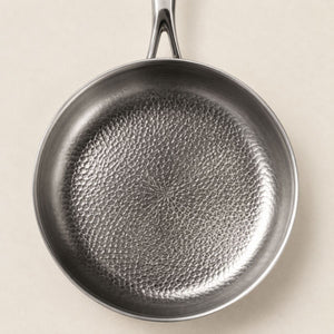 Overhead close-up of the hammered honeycomb cooking surface of the titanium pan