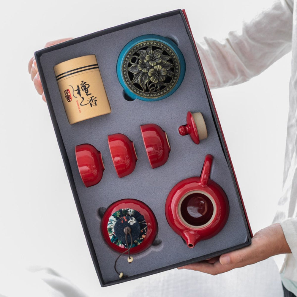 Red gift box being opened on the Jing red porcelain tea set
