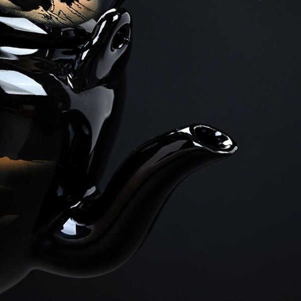 Close-up of the curved spout on the Kumo black ceramic teapot