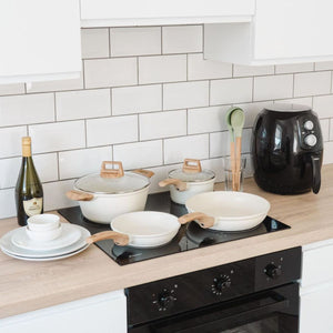 Mikage cookware set on an induction cooktop in a white kitchen