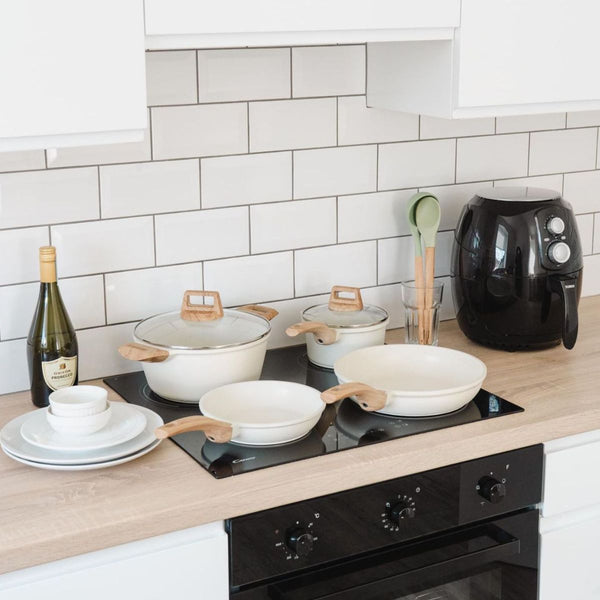 Mikage cookware set on an induction cooktop in a white kitchen