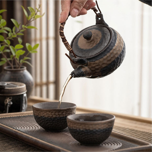 Tea poured from the Renji pottery teapot into a cup on the serving tray