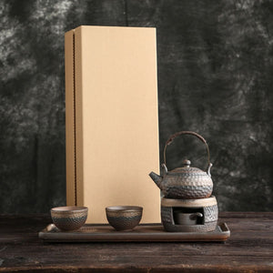 Renji pottery tea set displayed in front of its packaging box