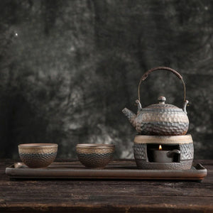 Renji pottery tea set on its serving tray with the candle warmer lit