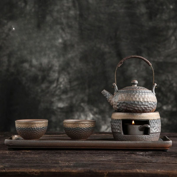 Renji pottery tea set on its serving tray with the candle warmer lit