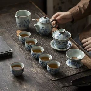 Rui Ruyao ceramic tea set in use with six filled tea cups, teapot, gaiwan and strainer