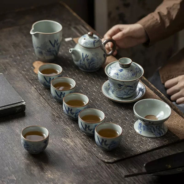 Rui Ruyao ceramic tea set in use with six filled tea cups, teapot, gaiwan and strainer