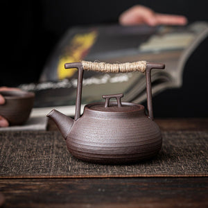 Sumi ceramic teapot on a wooden table during a tea session