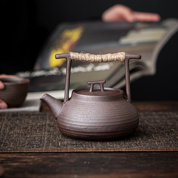 Sumi ceramic teapot on a wooden table during a tea session