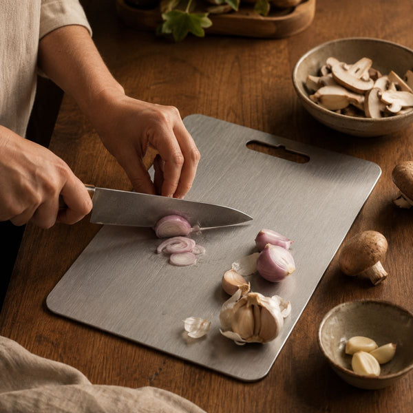 Shallots and garlic being chopped on the titanium cutting board