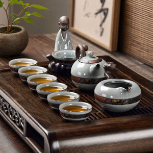 Yunlong Ruyao ceramic tea set on a wooden tea tray with six filled tea cups