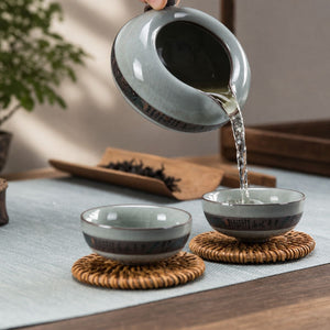 Tea poured from the Yunlong ceramic fair cup into two tea cups
